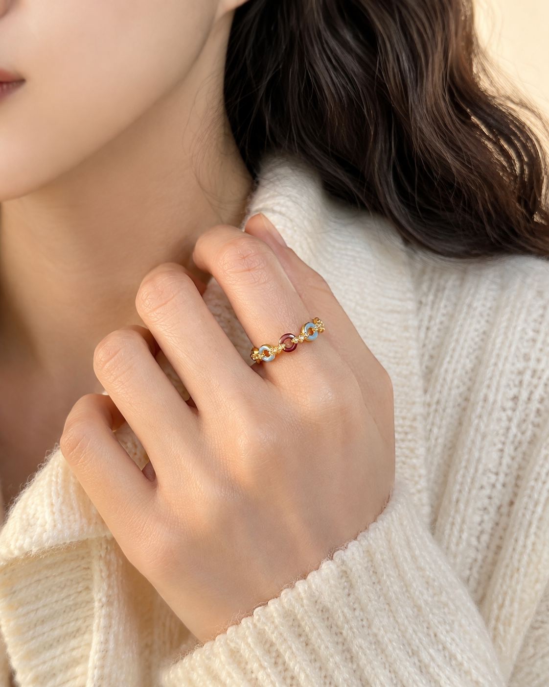 Editorial hand view of the Carmine Cadence Open Ring with its open terminals and linked colored front