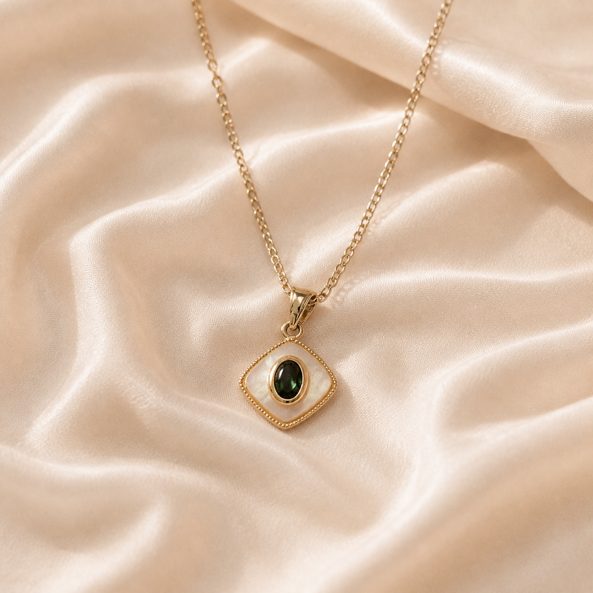 Sable Eclipse Pendant Necklace with a warm gold-toned chain and diamond-shaped pale pendant.