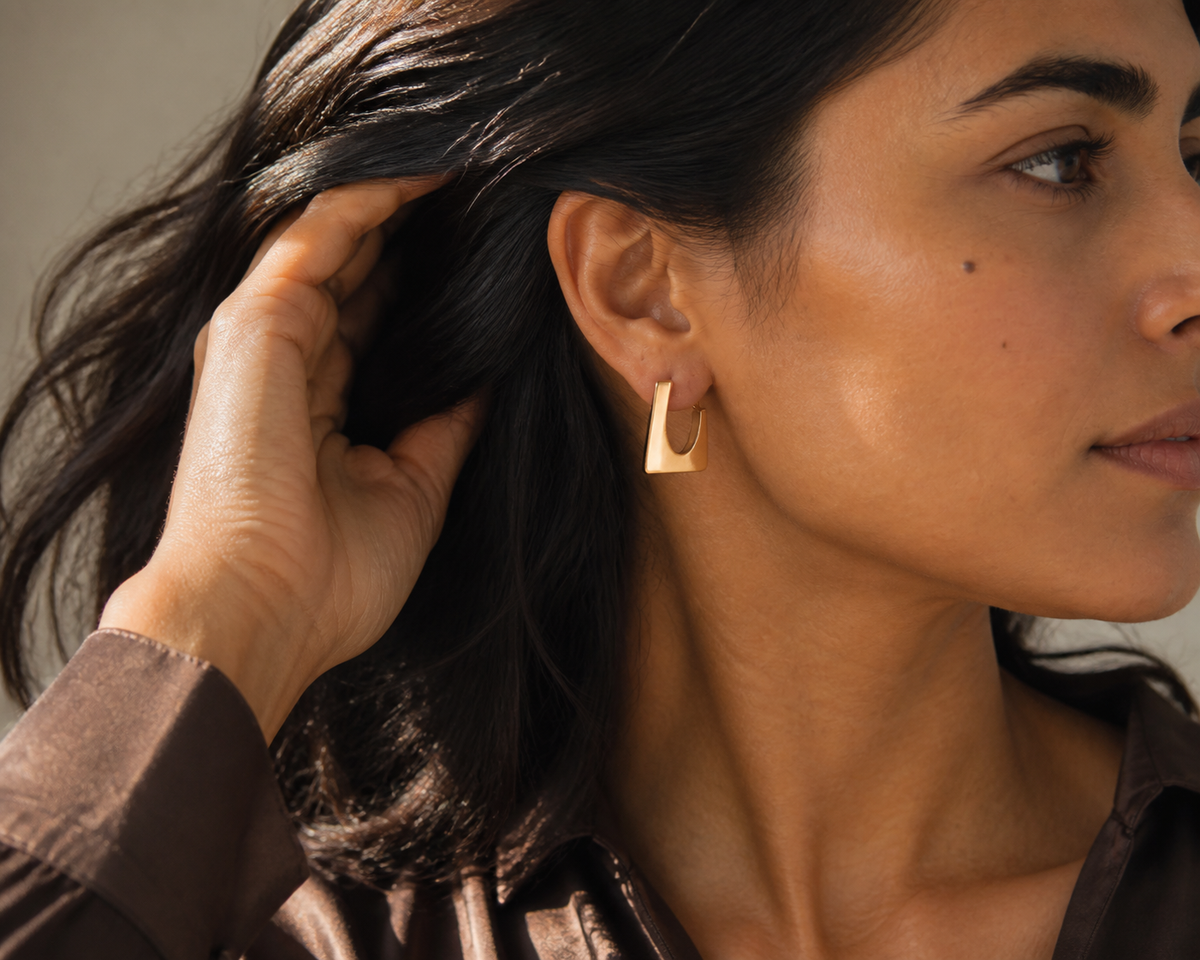 Ember Portal Earrings worn in a partial-face directional-light editorial close crop
