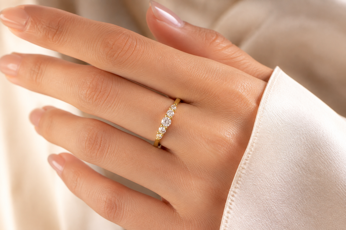 Hand wearing the Fivefold Spark Ring with its five-part graduated setting in view