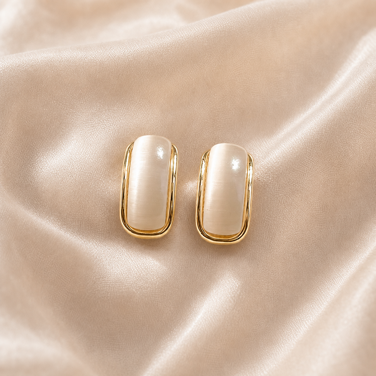 Moonlit Arc Stud Earrings styled on Moonveil warm cream silk