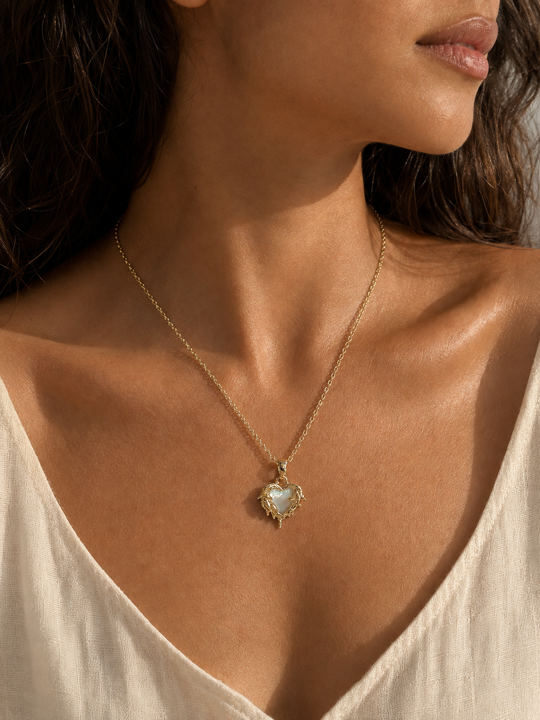 Candlelit Flame Pendant Necklace in a close editorial portrait, showing the pale heart centre and pointed lower terminal.