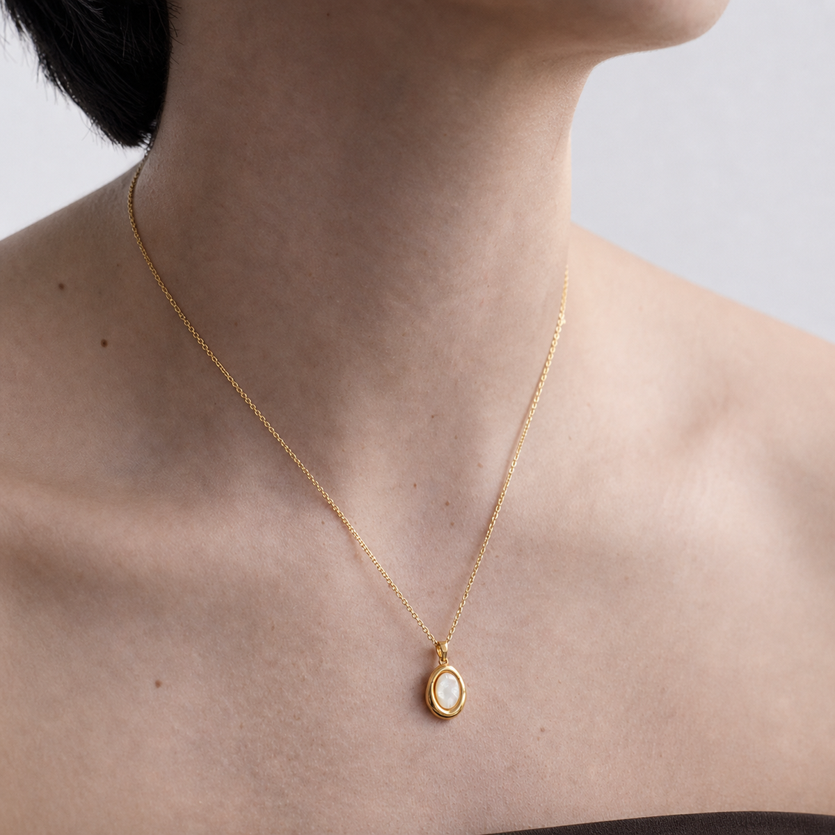 Pale Cameo Shell Pendant Necklace worn in a natural editorial portrait