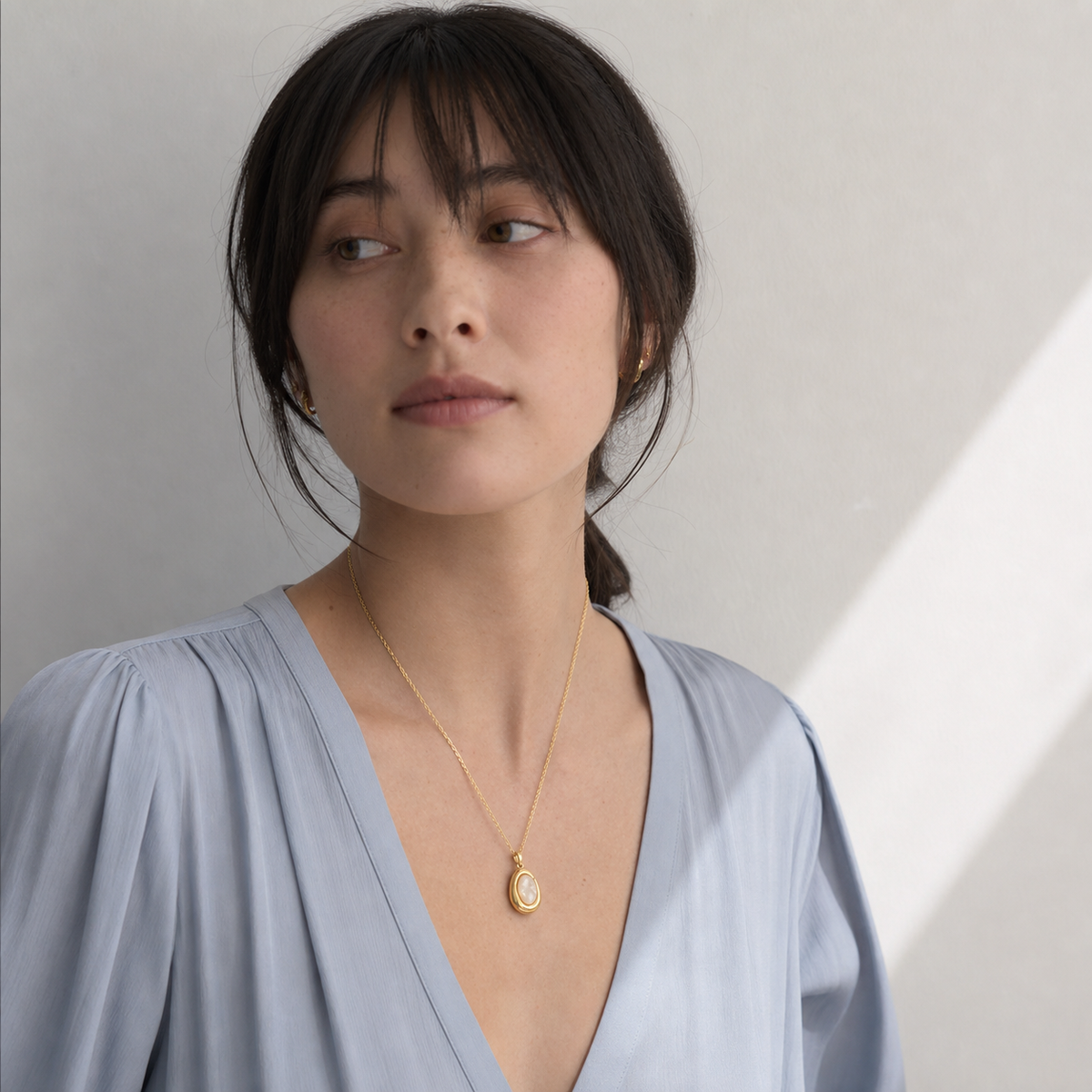 A second photographic styling view of Pale Cameo Shell Pendant Necklace