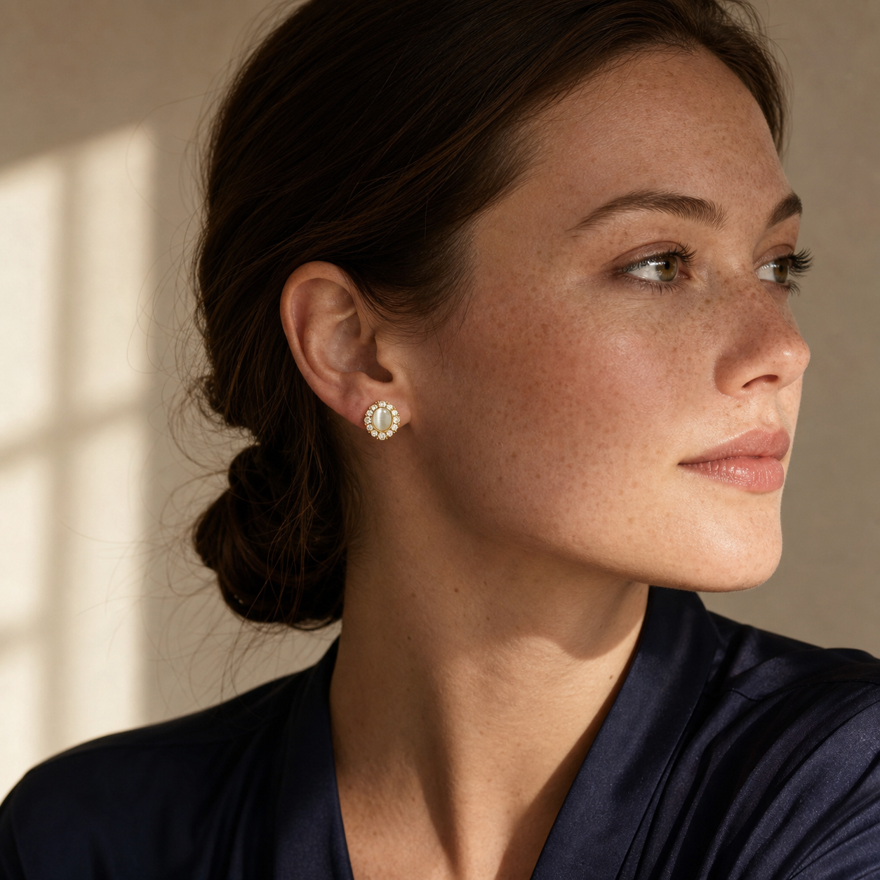 A second photographic styling view of Pale Gaze Halo Stud Earrings