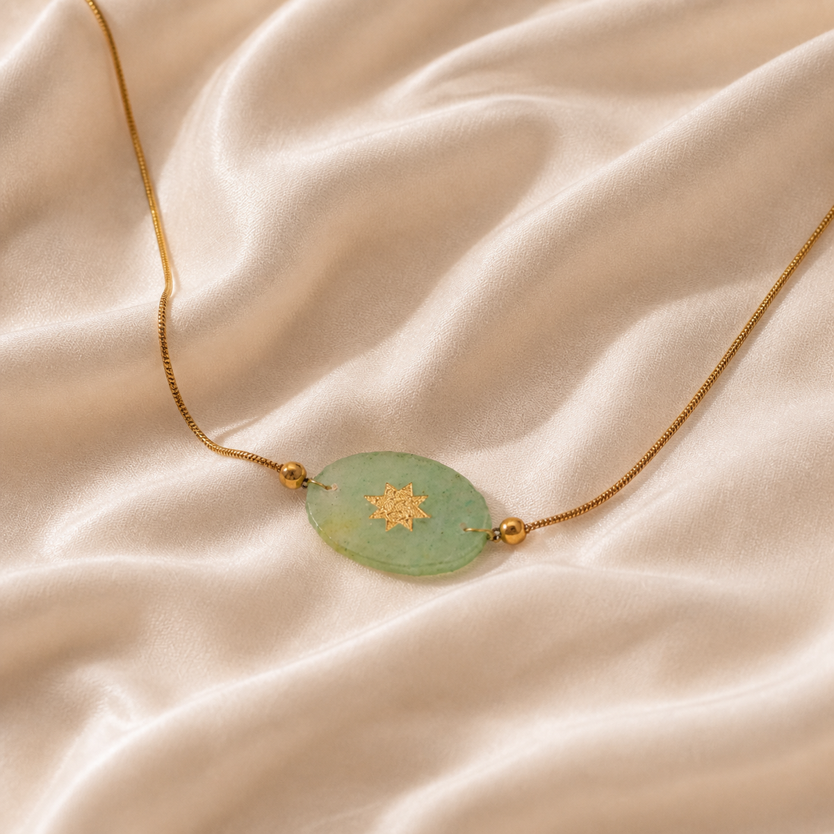 Quiet Solar Oval Necklace styled on Moonveil warm cream silk