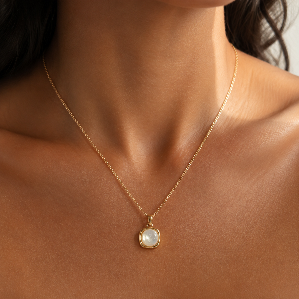 Hushed Summer rounded-square pendant necklace worn at the collarbone.