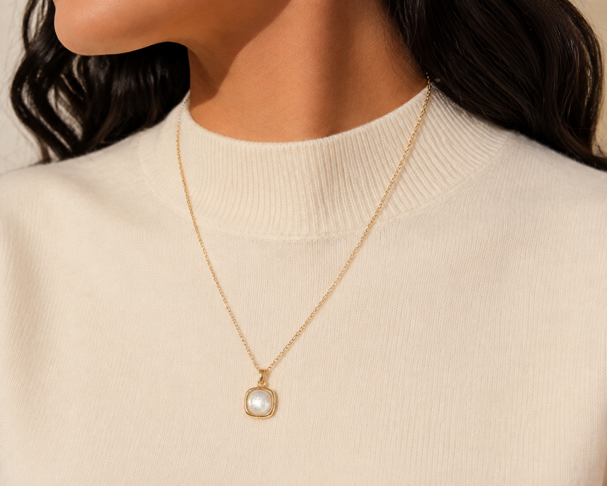 Hushed Summer rounded-square pendant necklace in a close editorial portrait.
