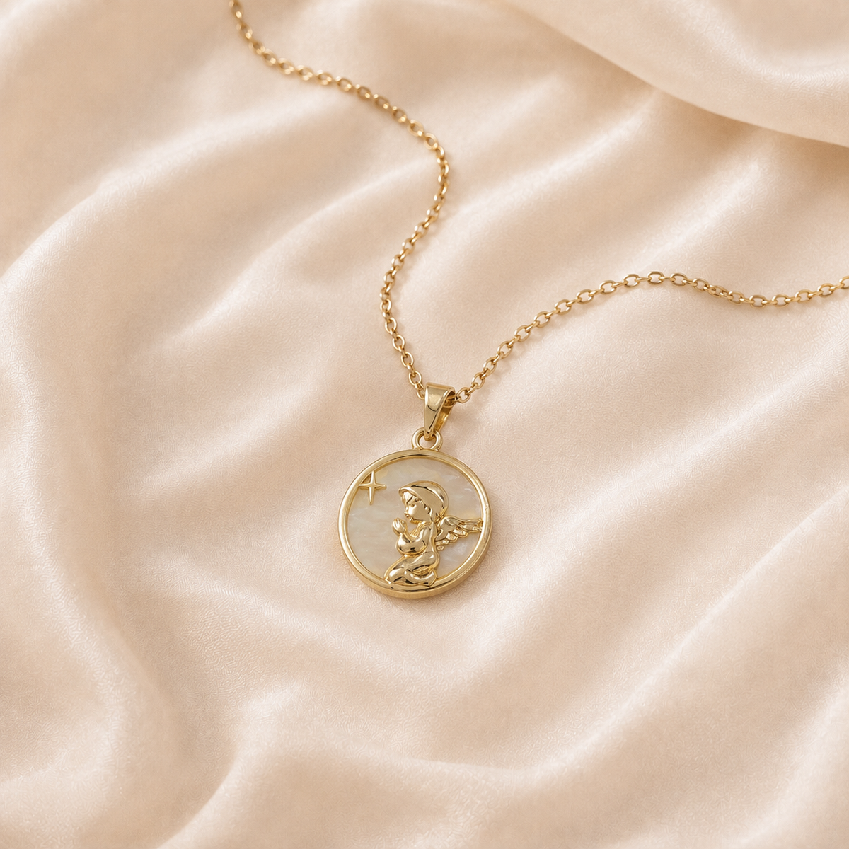 Star Relief Medallion Necklace with a warm gold-toned chain and pale iridescent medallion on cream silk.