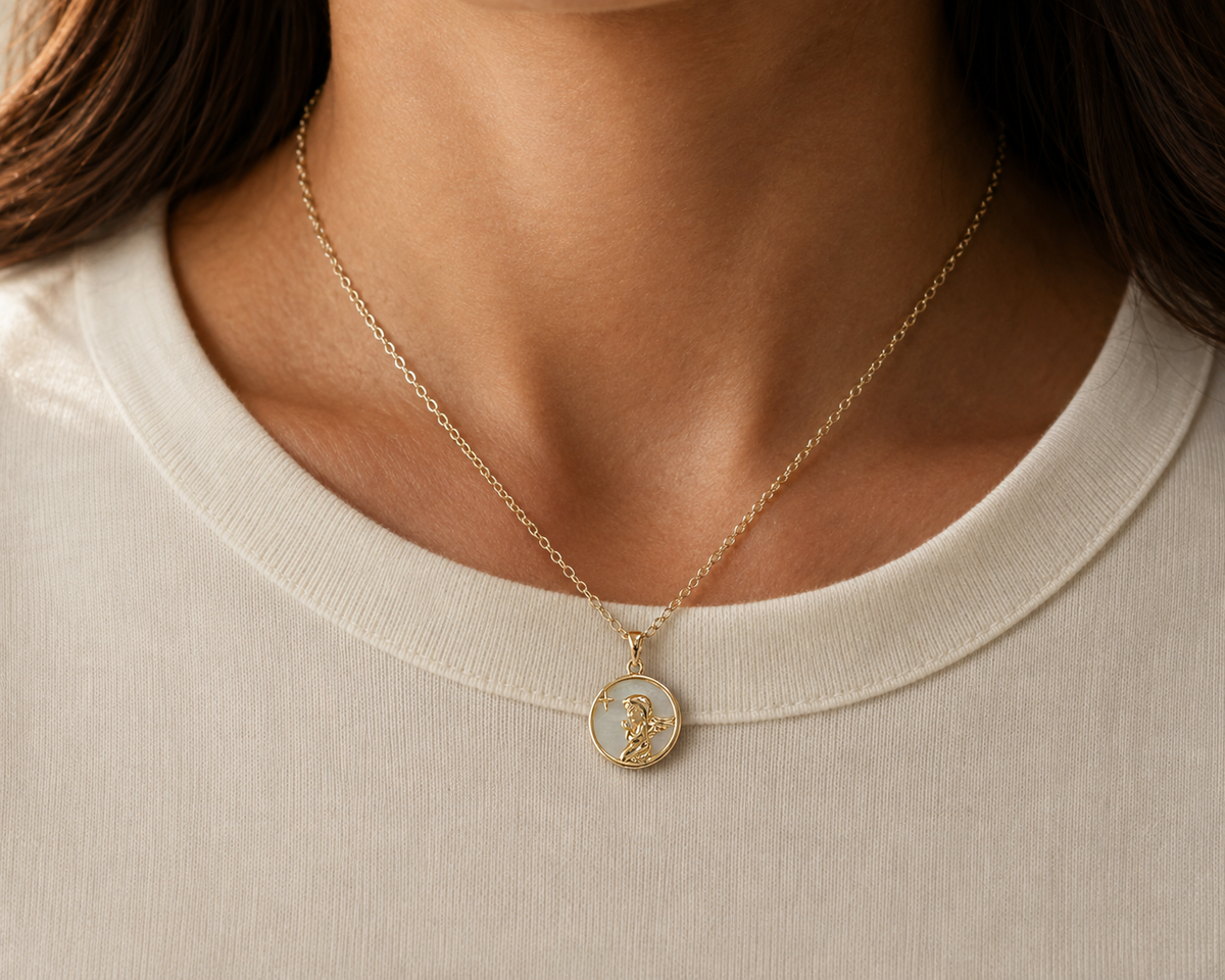 Star Relief Medallion Necklace worn at the collarbone, with its round pale iridescent medallion visible.