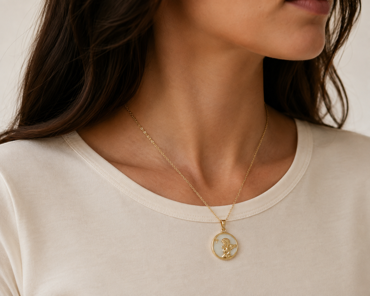 Star Relief Medallion Necklace in a close editorial portrait, showing the small raised star and gold-toned relief.
