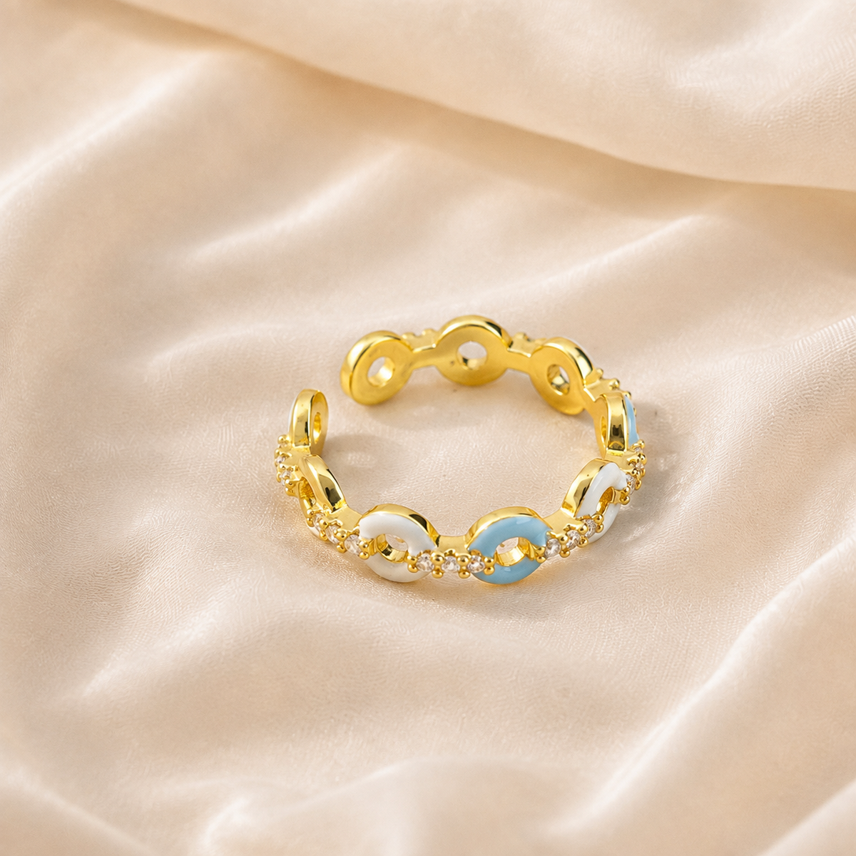 Azure Talisman Open Ring with pale-blue and ivory links, gold-toned separators, and rounded open terminals.