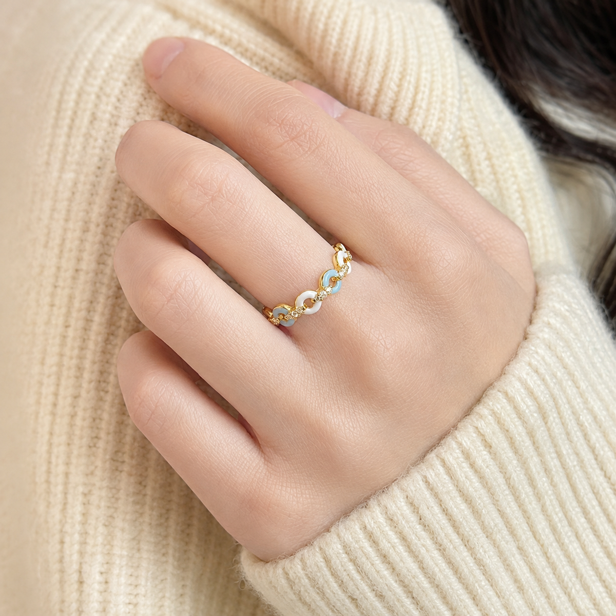 Azure Talisman Open Ring worn on a hand, showing its pale-blue and ivory linked front.