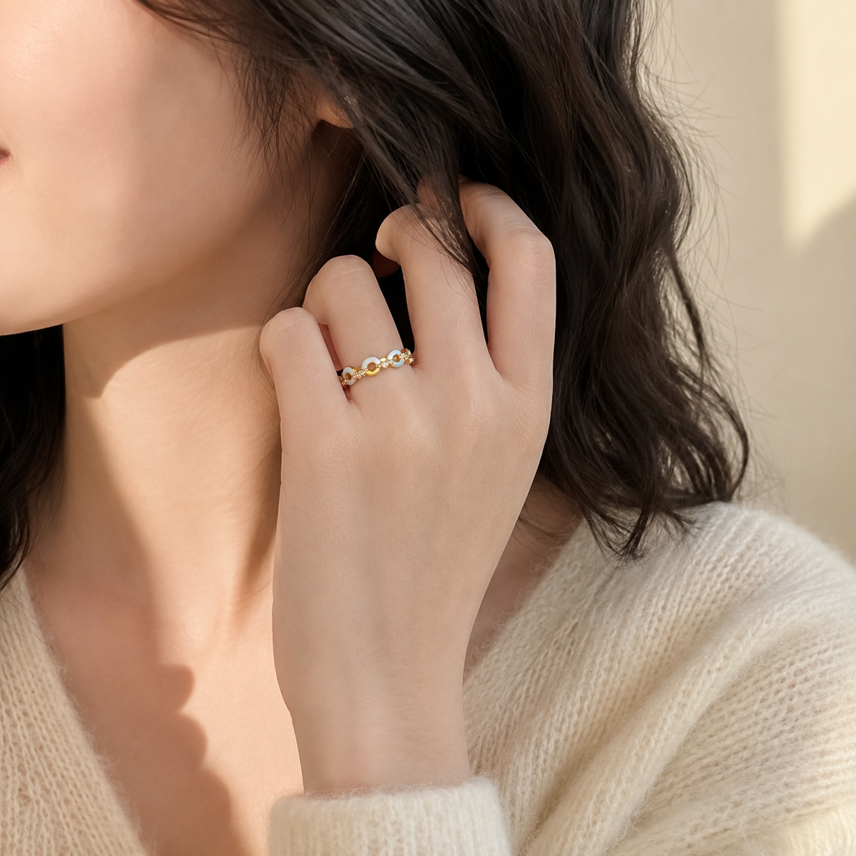 Side view of a hand wearing the Azure Talisman Open Ring with pale-blue and ivory links.