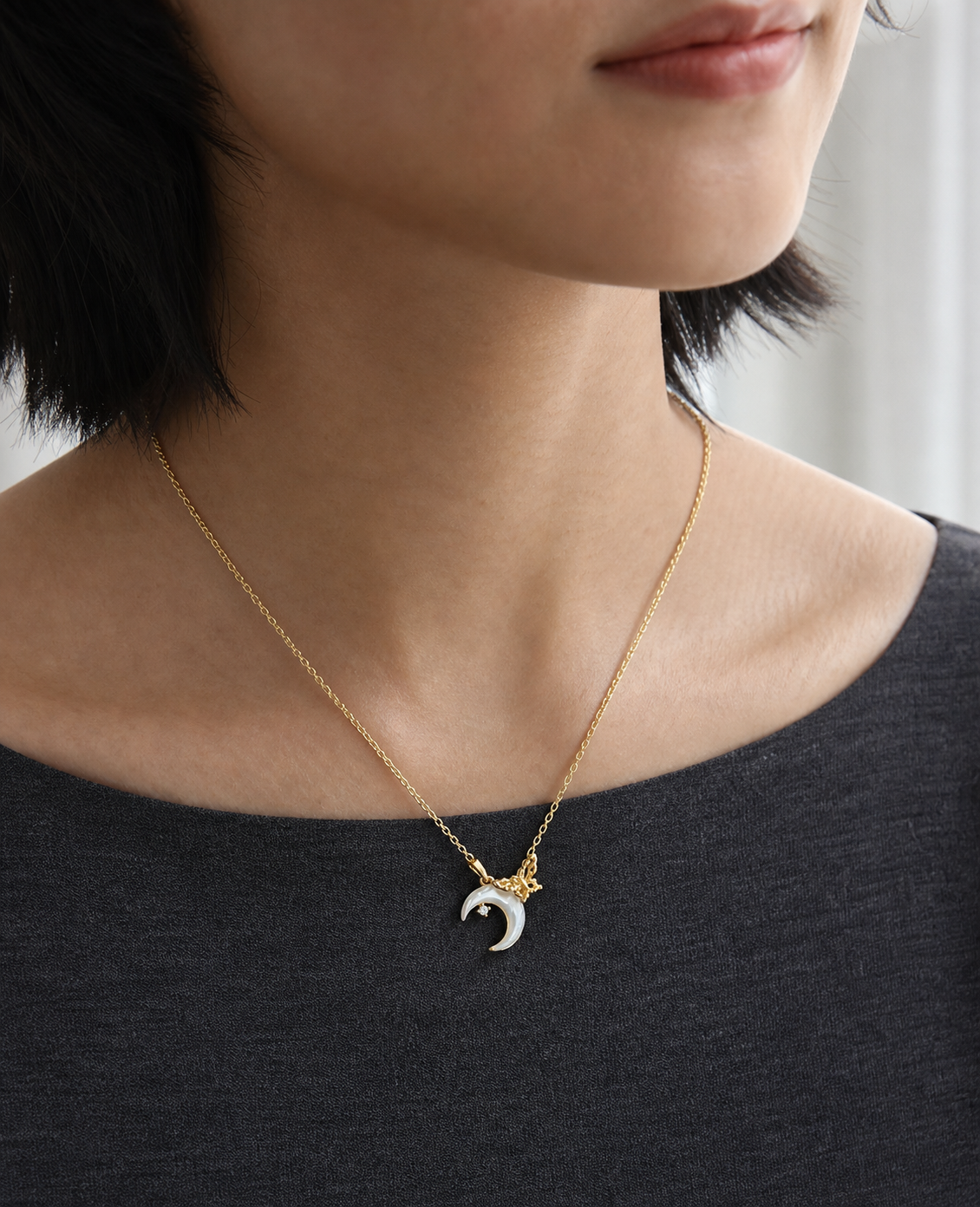Crescent Wing Shell Pendant Necklace worn in a natural editorial portrait