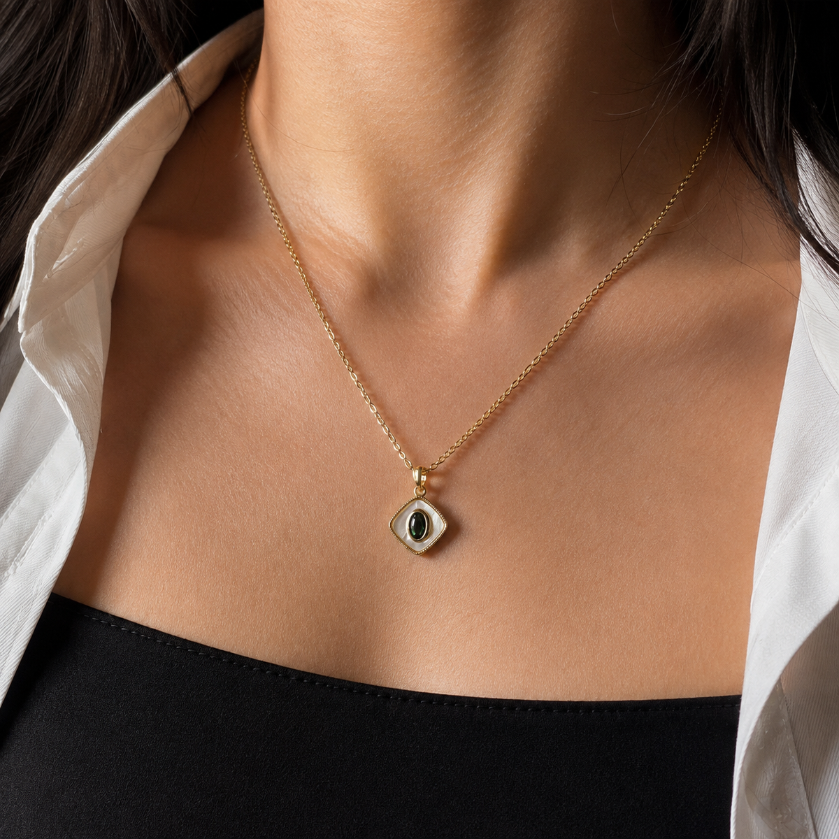 Sable Eclipse Pendant Necklace worn at the neckline, showing the centered diamond-shaped pendant.