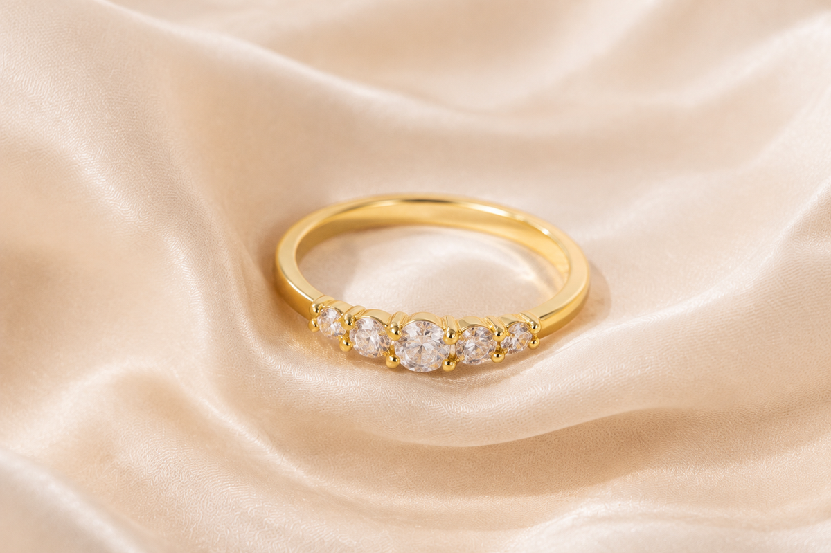Fivefold Spark Ring with five graduated clear zircon accents on cream silk