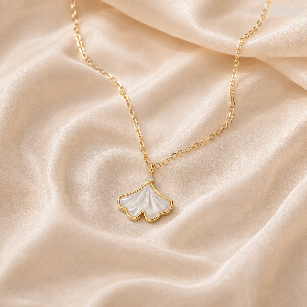 Pale Fanleaf Pendant Necklace with a mother-of-pearl shell leaf centered on cream silk