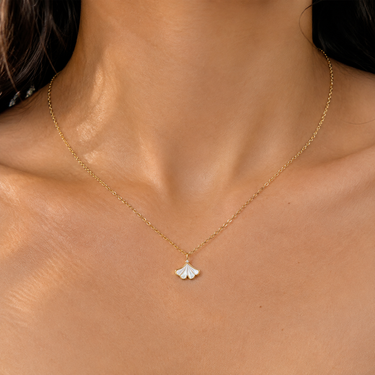 Close neckline view wearing the Pale Fanleaf Pendant Necklace