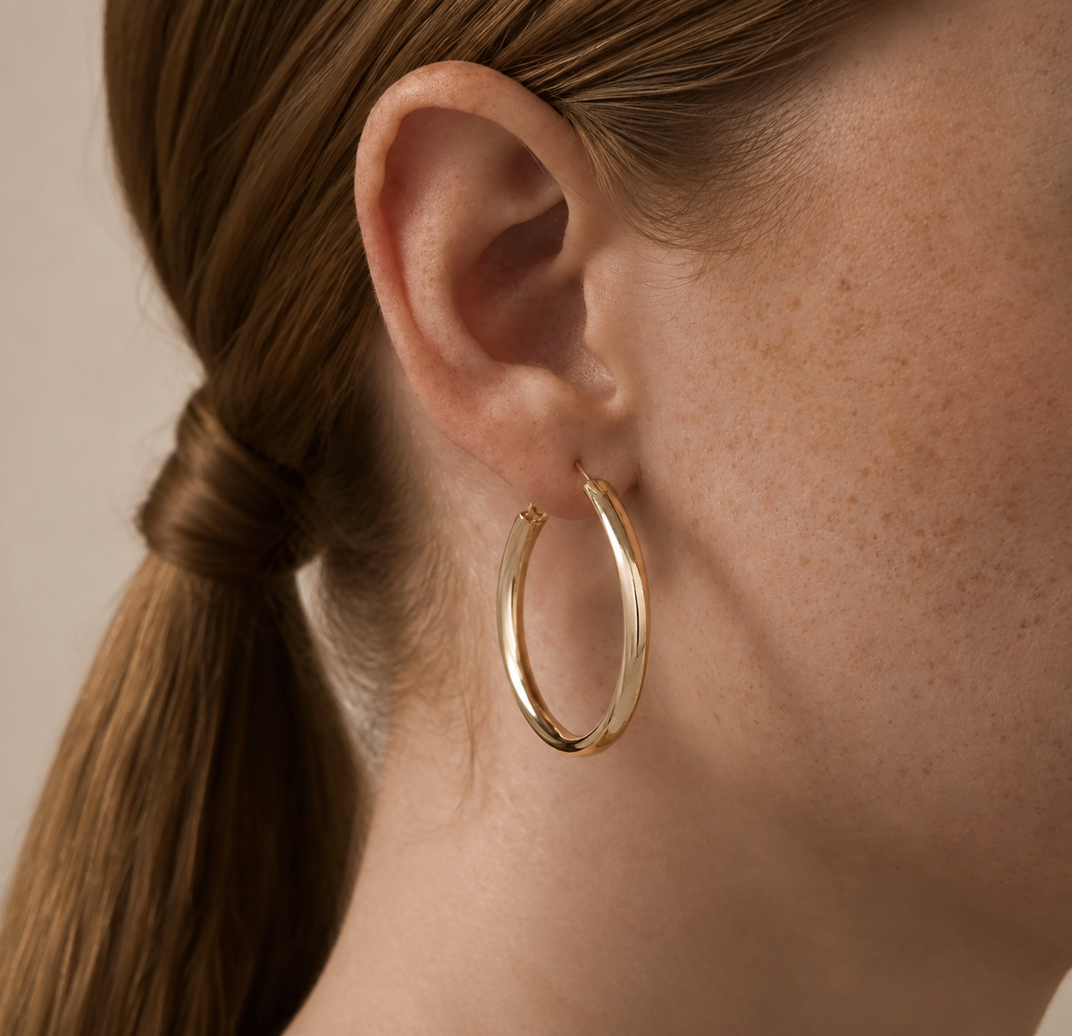 Heatfold Hoop Earrings worn in a natural editorial view