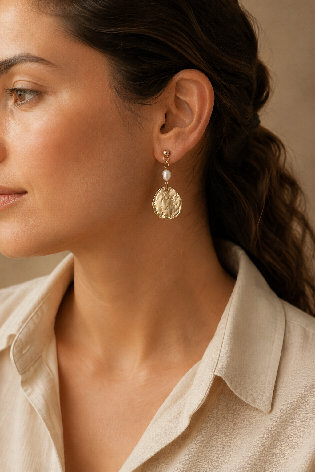 Editorial side view wearing the Dappled Disc Pearl Drop Earrings