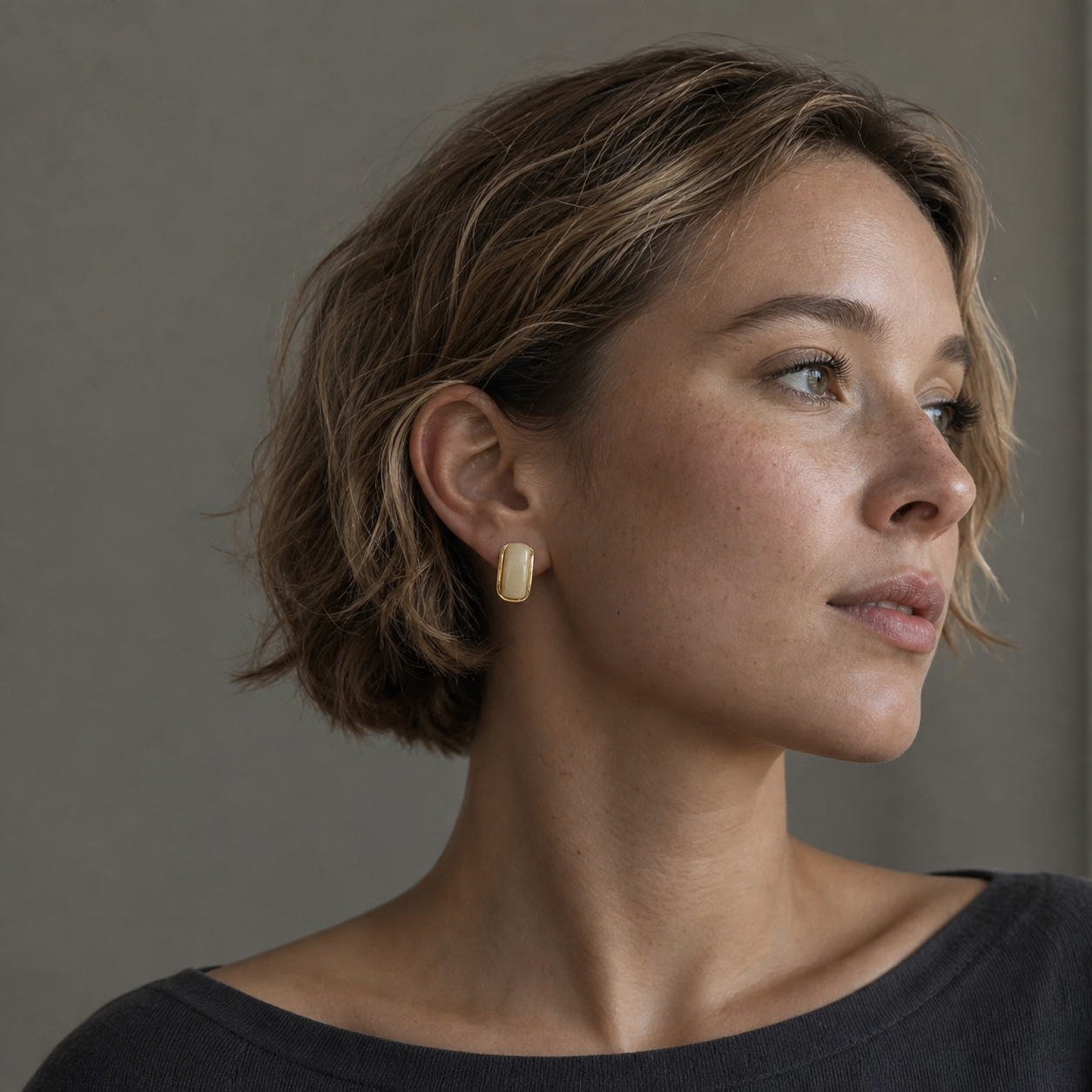 A second photographic styling view of Moonlit Arc Stud Earrings