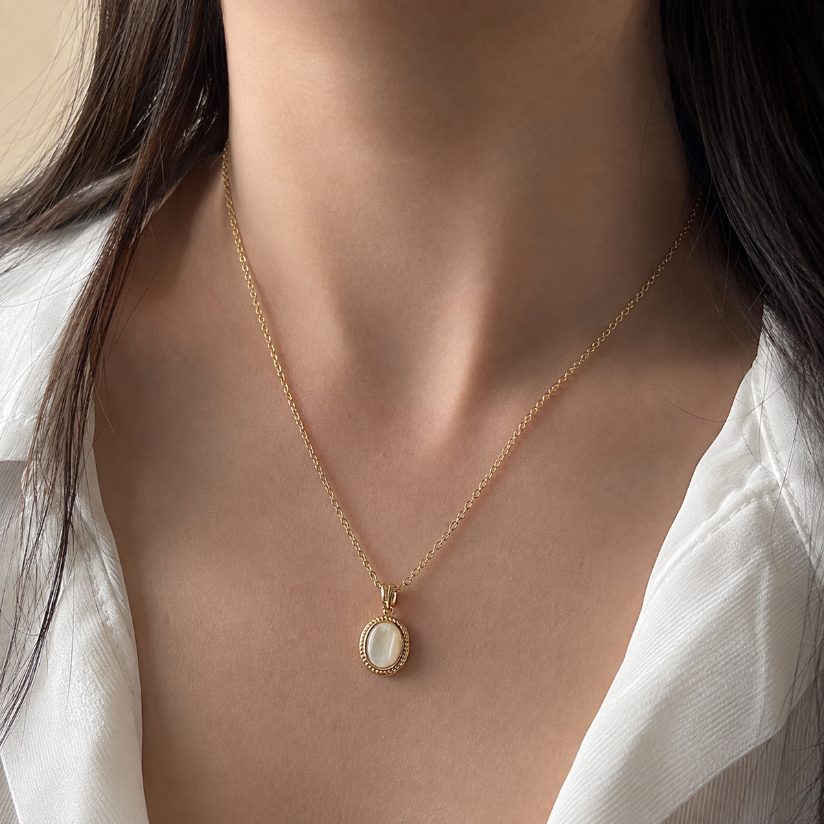Gilt Memento Pendant Necklace worn at the upper chest in a close view