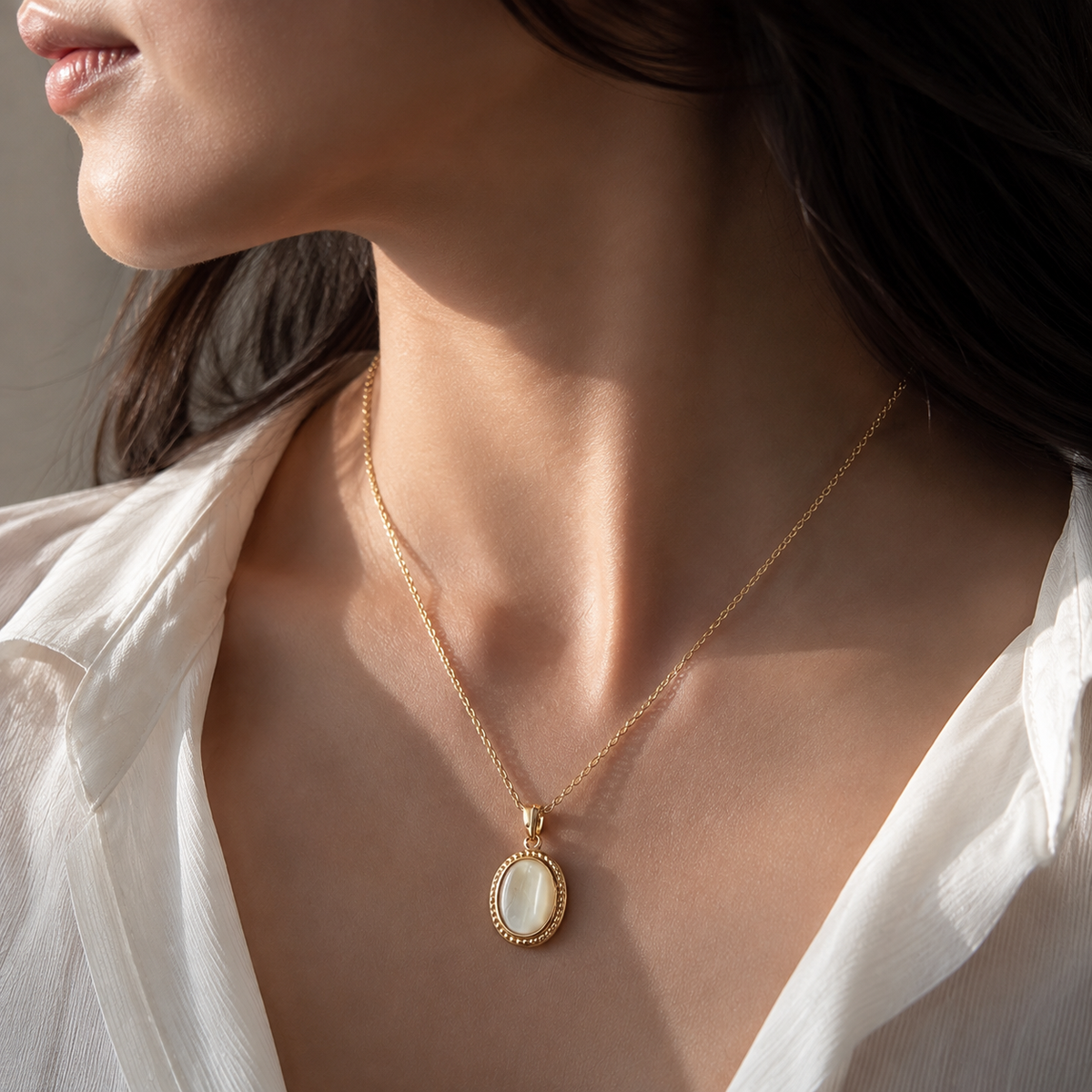Gilt Memento Pendant Necklace worn on a fine single chain in an editorial view