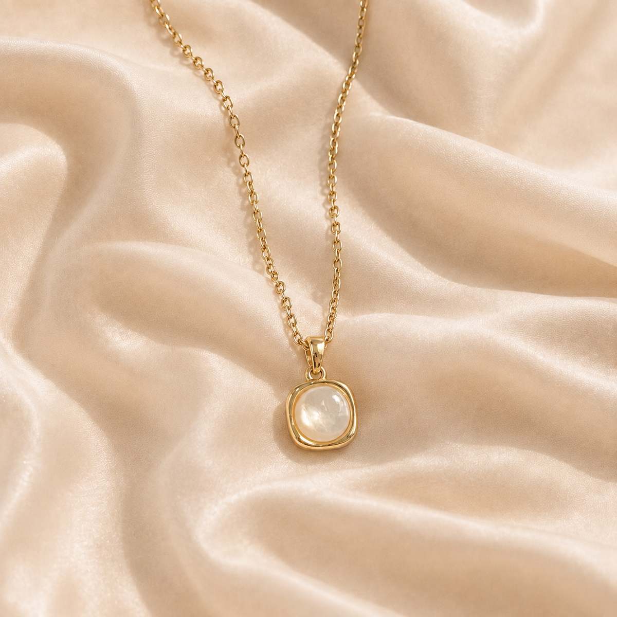 Hushed Summer pendant necklace with a pale cream-white iridescent centre on cream silk.