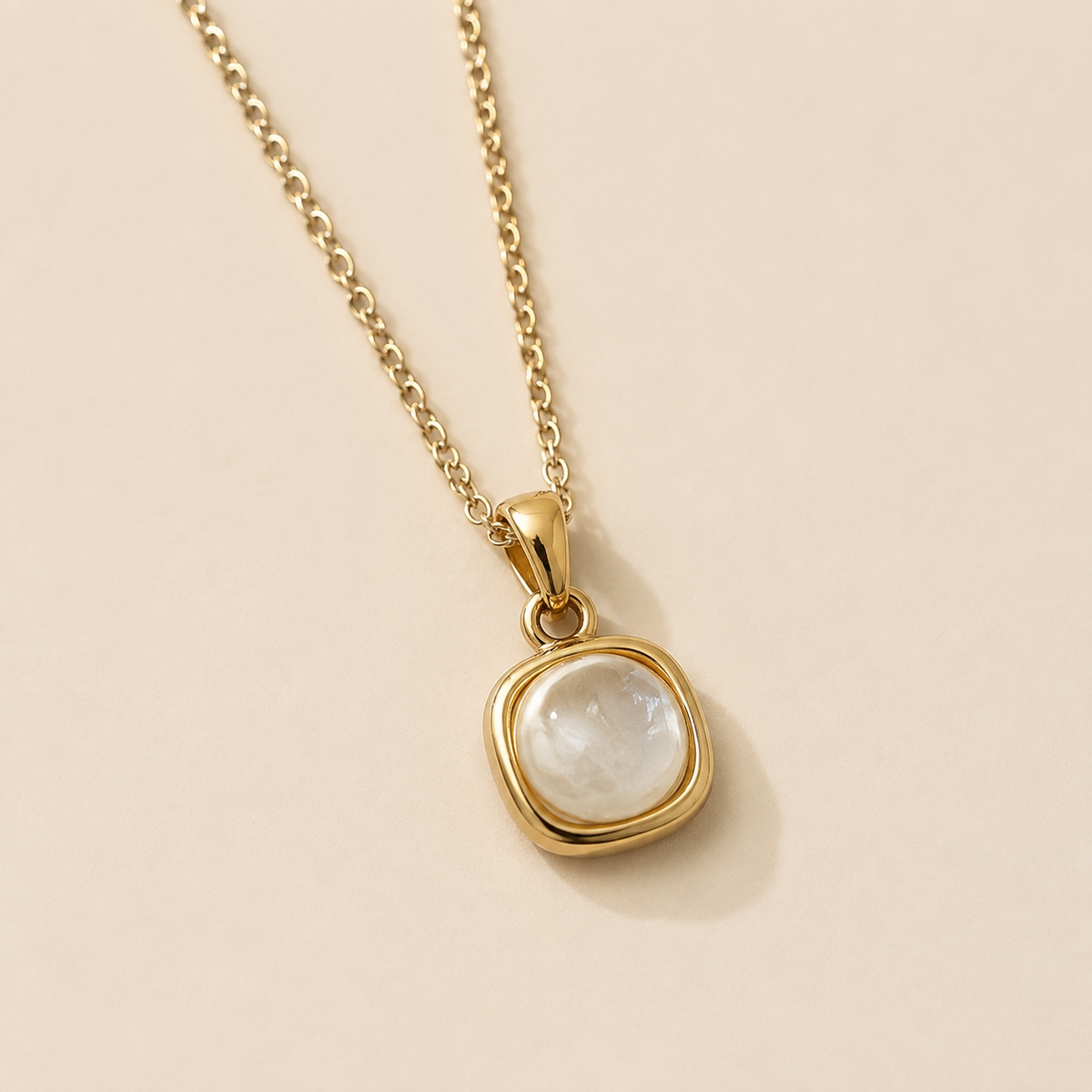 Close view of the Hushed Summer rounded-square pendant, smooth bezel, bail, and connector.