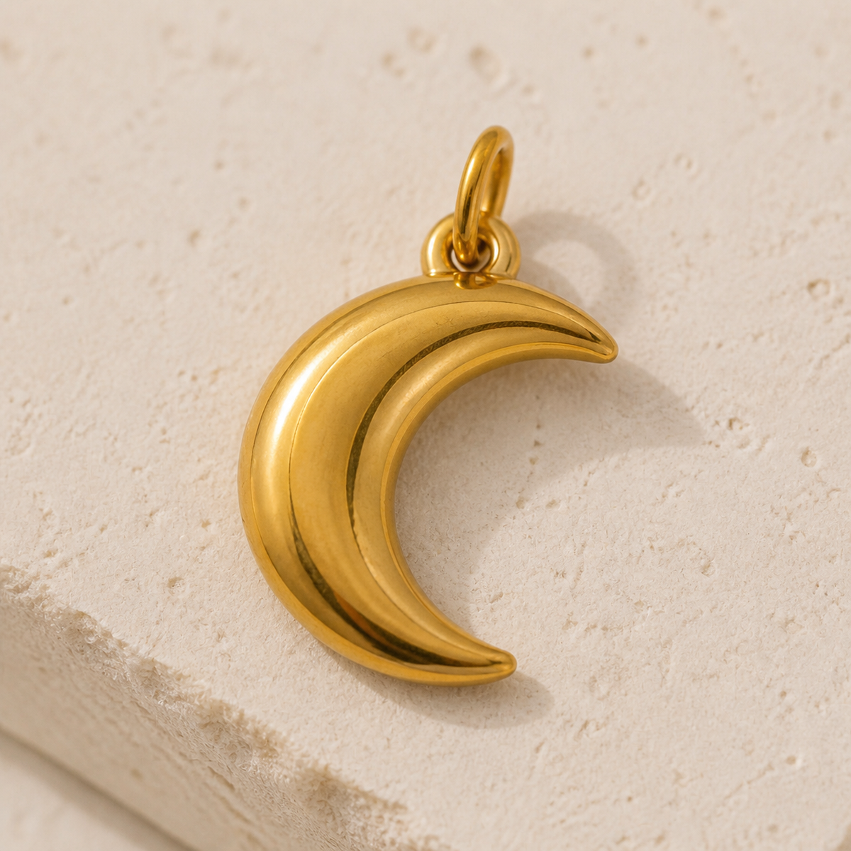 Close-up of Sculpted Moon Charm showing its design and finish