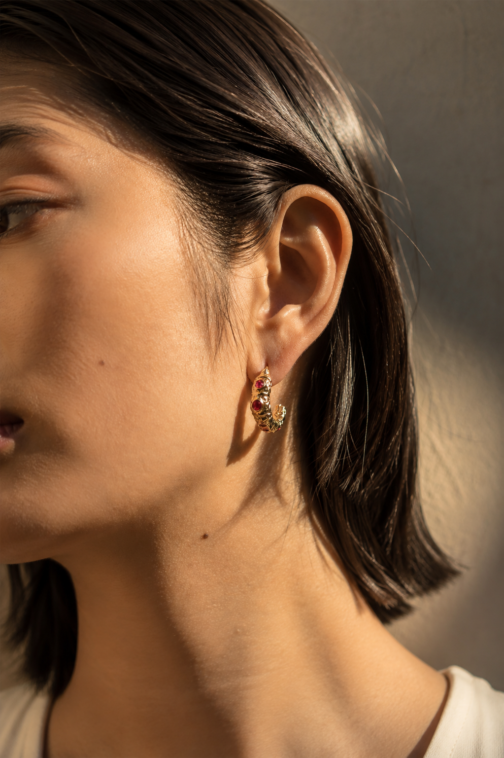 Side-profile editorial view wearing the Vermilion Contour Earrings